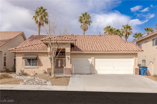 mediterranean / spanish-style home featuring a garage, brick siding, concrete driveway, a tiled roof, and stucco siding