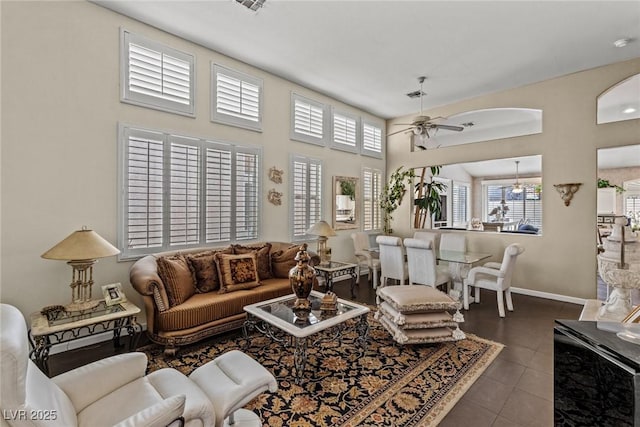 living area featuring a ceiling fan, visible vents, plenty of natural light, and tile patterned floors