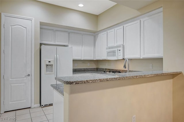 kitchen featuring white appliances, light tile patterned floors, light stone counters, a peninsula, and white cabinetry