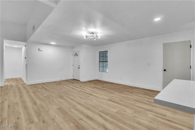 unfurnished living room featuring recessed lighting, light wood-type flooring, and baseboards