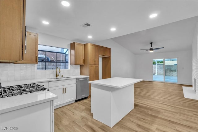 kitchen with visible vents, light wood-style flooring, plenty of natural light, a sink, and stainless steel dishwasher