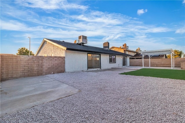 back of house featuring fence, central AC, stucco siding, a patio area, and a pergola