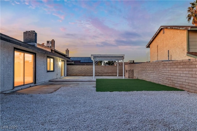 view of yard with a patio, a fenced backyard, and a pergola