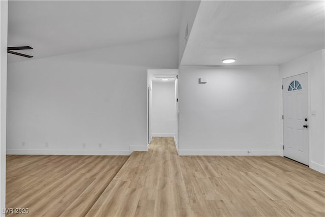 spare room with light wood-style floors and baseboards