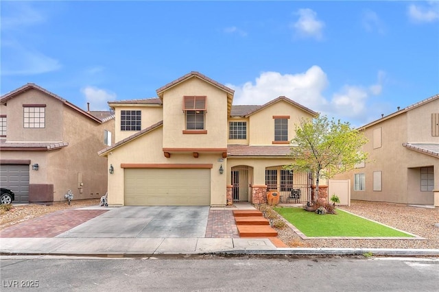 view of front of home with a tile roof, concrete driveway, a front yard, stucco siding, and an attached garage