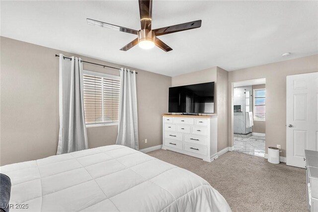 bedroom featuring light colored carpet, baseboards, and ceiling fan