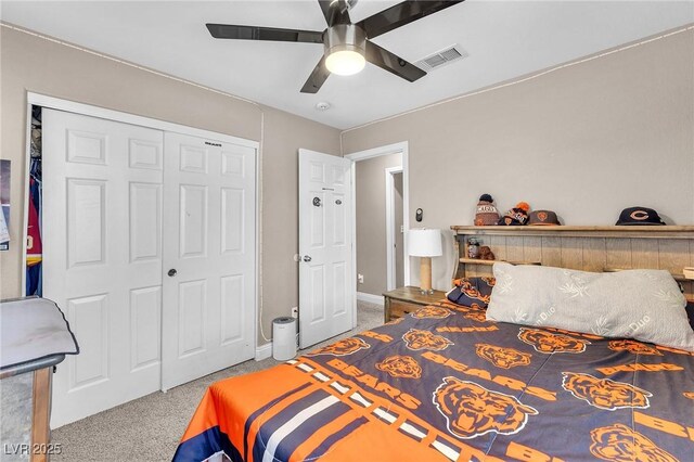 bedroom featuring carpet flooring, a ceiling fan, visible vents, and a closet