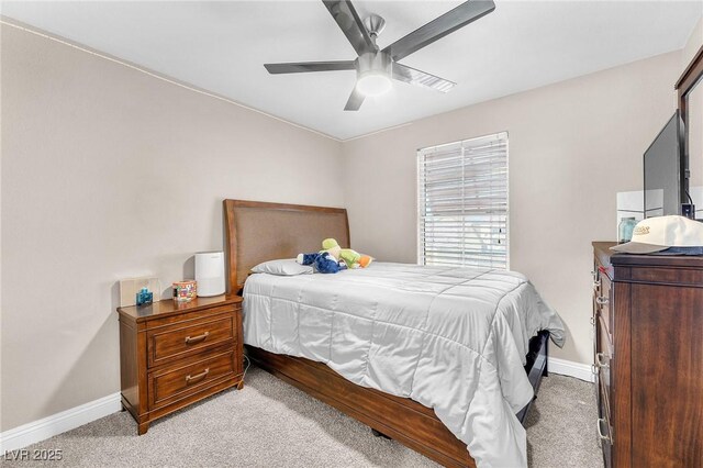 bedroom with light colored carpet, baseboards, and ceiling fan