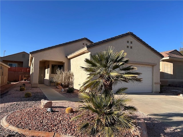 view of property exterior with driveway, an attached garage, a tiled roof, and stucco siding