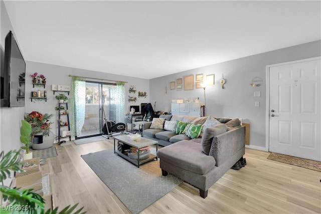 living room featuring light wood-style flooring and baseboards