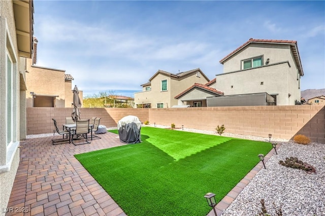 view of yard featuring a patio and a fenced backyard