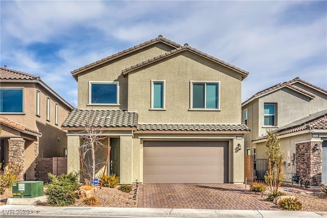 view of front of property with decorative driveway, stucco siding, central AC unit, fence, and a garage