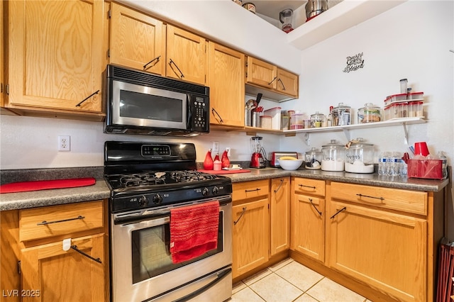 kitchen with dark countertops, light tile patterned floors, appliances with stainless steel finishes, and open shelves