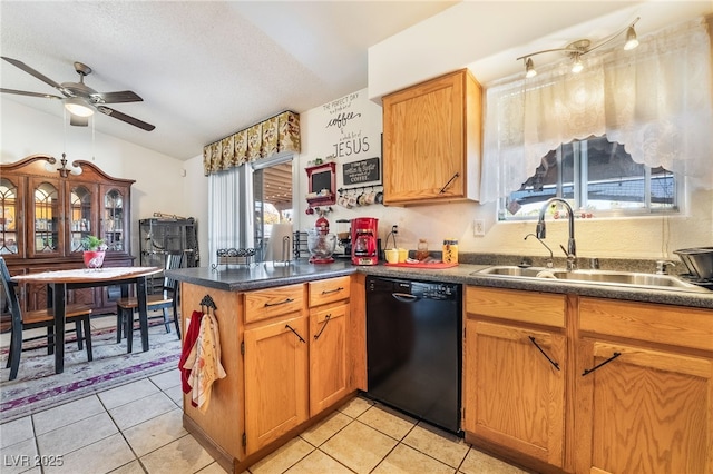 kitchen with light tile patterned floors, a peninsula, a sink, black dishwasher, and dark countertops