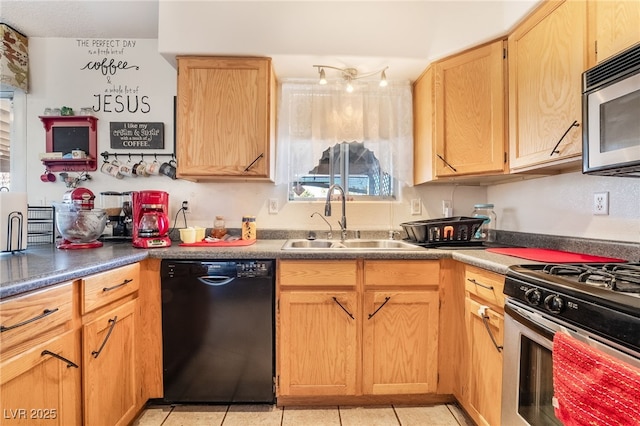 kitchen featuring stainless steel appliances, dark countertops, a sink, and light tile patterned floors