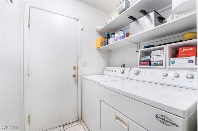 laundry area with laundry area, washer and clothes dryer, and light tile patterned flooring