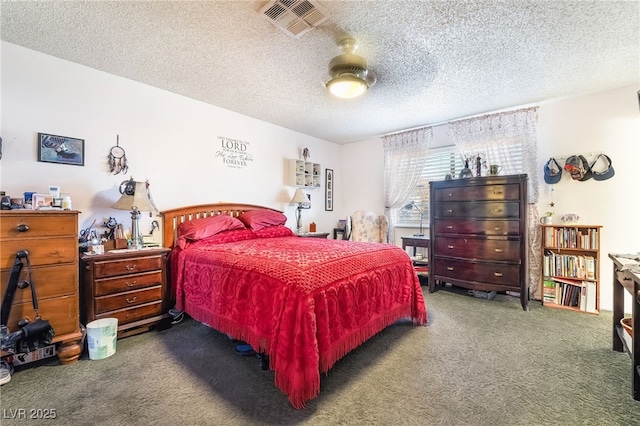 carpeted bedroom with a textured ceiling, visible vents, and a ceiling fan