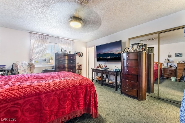 bedroom featuring a ceiling fan, carpet, visible vents, and a textured ceiling