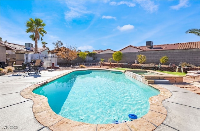 view of swimming pool featuring a patio, cooling unit, a fenced backyard, and a pool with connected hot tub