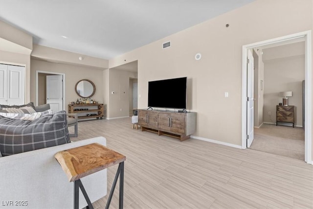 living room featuring visible vents and baseboards