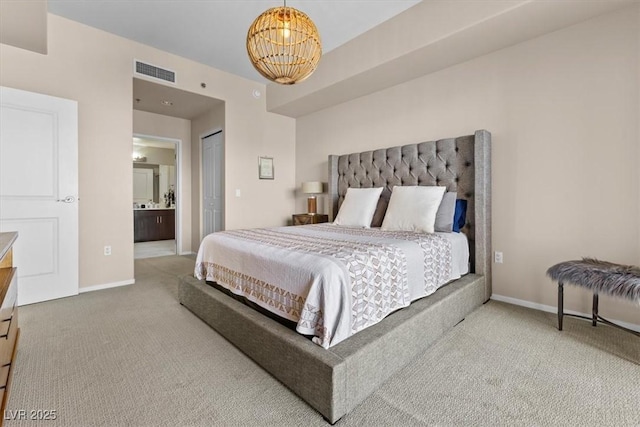 bedroom featuring carpet floors, a notable chandelier, visible vents, ensuite bath, and baseboards