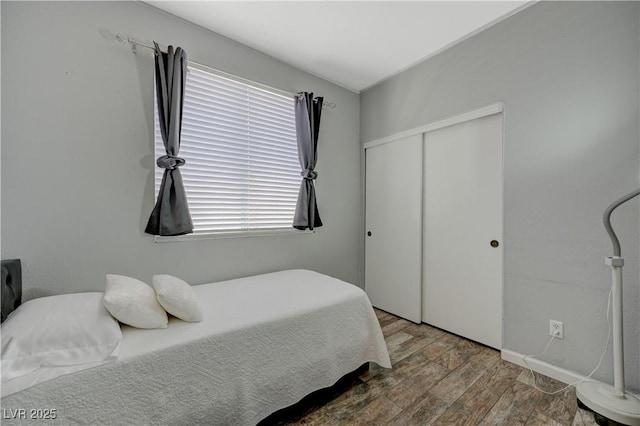 bedroom featuring a closet and wood finished floors