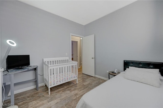 bedroom featuring light wood-type flooring and baseboards