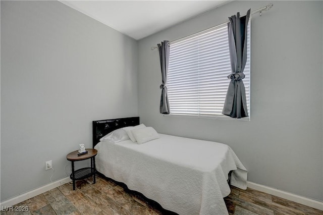 bedroom with baseboards and dark wood finished floors