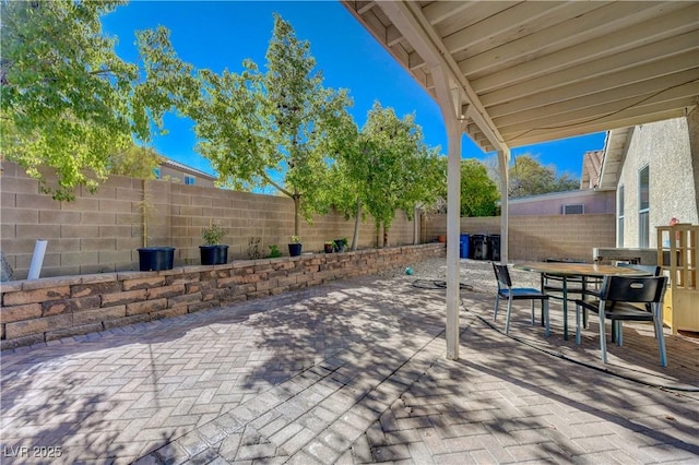 view of patio featuring outdoor dining area and a fenced backyard