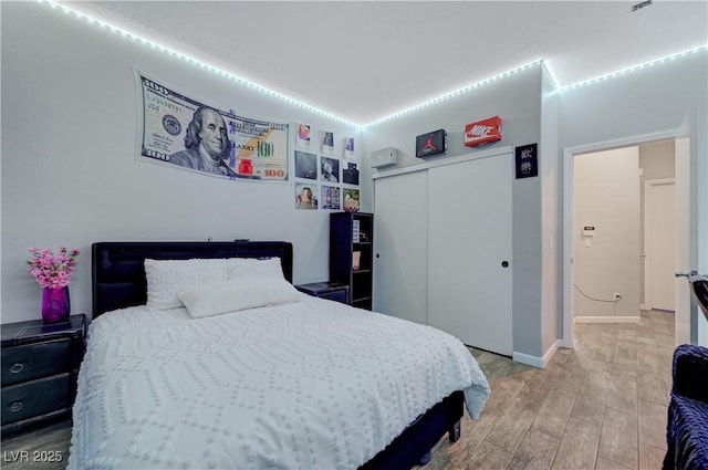 bedroom featuring a closet and wood finished floors