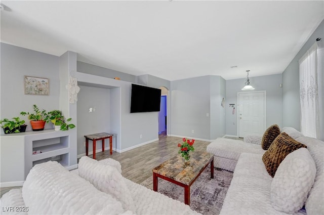 living room featuring light wood-style flooring and baseboards