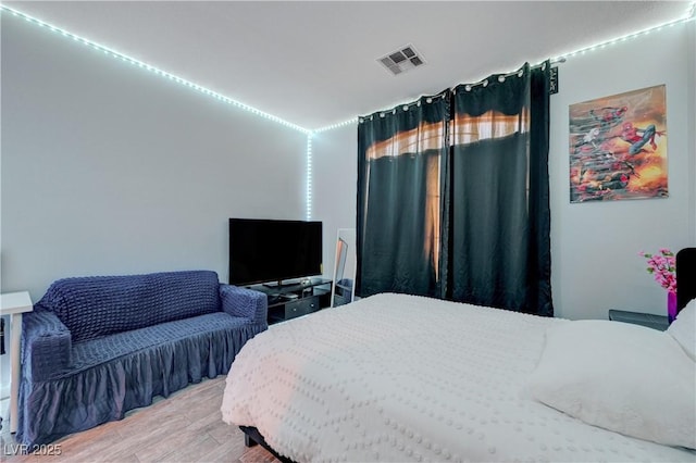 bedroom featuring light wood-type flooring and visible vents