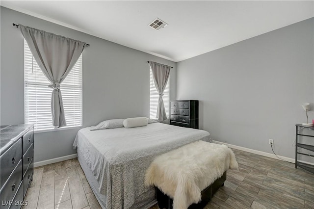 bedroom featuring dark wood-style floors, baseboards, and visible vents