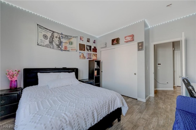 bedroom featuring light wood-style floors and baseboards