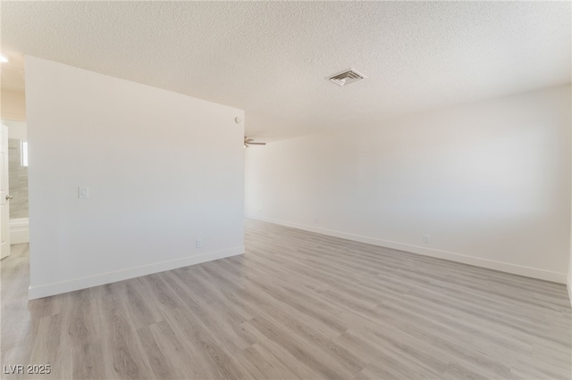 1817 Allen Ave, Henderson, NV 89011 - empty room with visible vents, a textured ceiling, baseboards, and light wood-type flooring