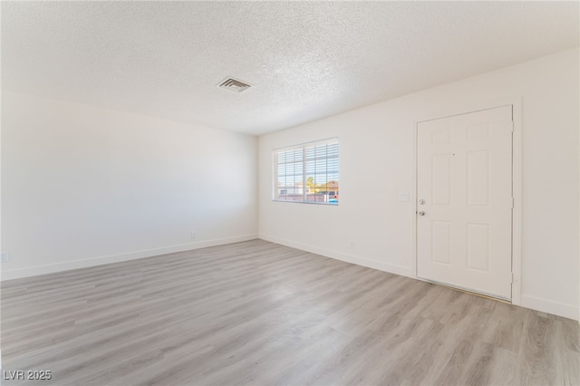 1817 Allen Ave, Henderson, NV 89011 - empty room featuring a textured ceiling, baseboards, light wood finished floors, and visible vents