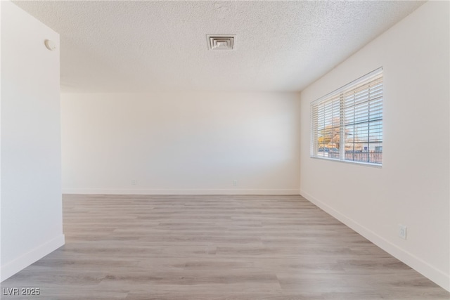 1817 Allen Ave, Henderson, NV 89011 - empty room featuring baseboards, visible vents, light wood-type flooring, and a textured ceiling