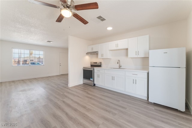 1817 Allen Ave, Henderson, NV 89011 - kitchen featuring under cabinet range hood, electric stove, a sink, visible vents, and freestanding refrigerator