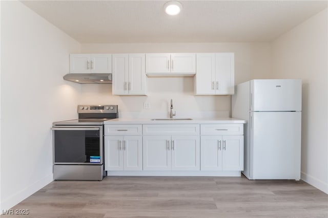 1817 Allen Ave, Henderson, NV 89011 - kitchen featuring stainless steel electric range, under cabinet range hood, a sink, freestanding refrigerator, and white cabinets