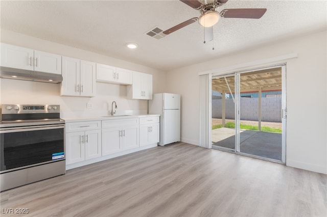 1817 Allen Ave, Henderson, NV 89011 - kitchen featuring under cabinet range hood, a sink, stainless steel range with electric cooktop, visible vents, and freestanding refrigerator