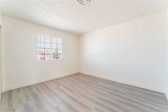 1817 Allen Ave, Henderson, NV 89011 - unfurnished room featuring baseboards, visible vents, light wood-style floors, and a textured ceiling