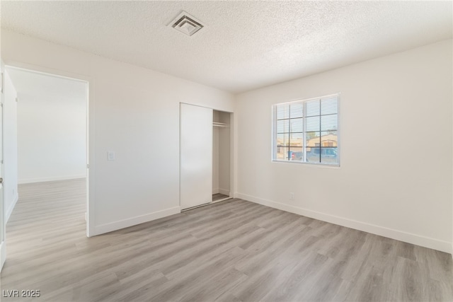 1817 Allen Ave, Henderson, NV 89011 - unfurnished bedroom featuring visible vents, a closet, light wood-style floors, and a textured ceiling