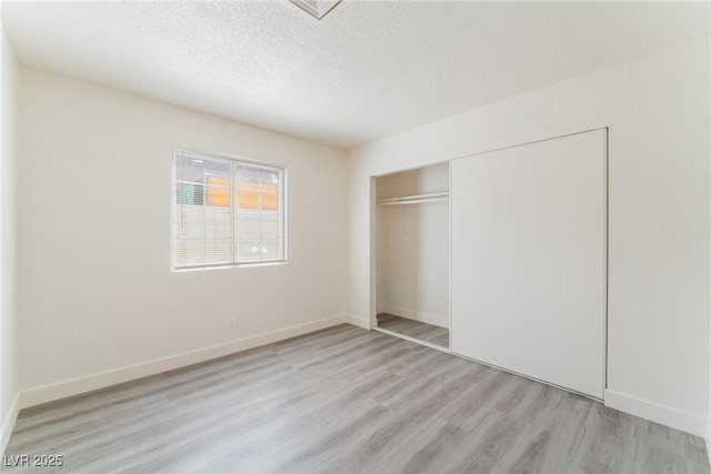 1817 Allen Ave, Henderson, NV 89011 - unfurnished bedroom with a closet, a textured ceiling, baseboards, and light wood-type flooring