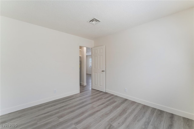 1817 Allen Ave, Henderson, NV 89011 - unfurnished room with light wood finished floors, baseboards, visible vents, and a textured ceiling