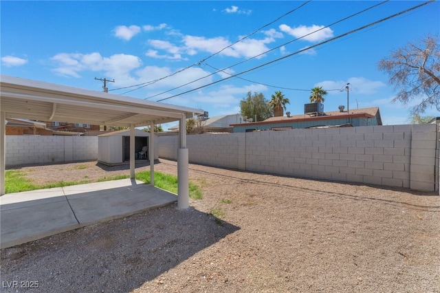 1817 Allen Ave, Henderson, NV 89011 - view of yard featuring a storage unit, a fenced backyard, a patio, and an outbuilding