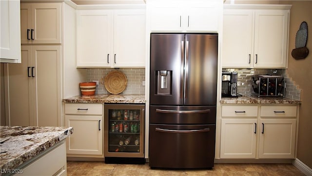 kitchen featuring stone countertops, white cabinets, wine cooler, stainless steel refrigerator with ice dispenser, and backsplash