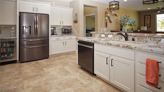 kitchen with dishwasher, wine cooler, light stone countertops, white cabinetry, and stainless steel refrigerator with ice dispenser