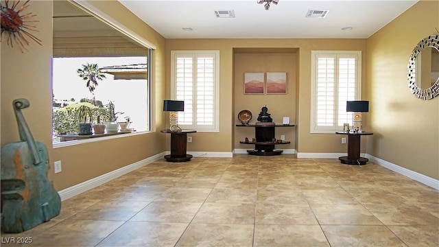 entryway featuring light tile patterned floors, visible vents, and baseboards