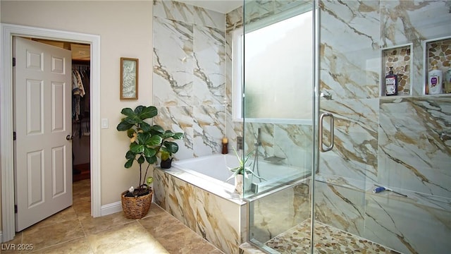 full bath with a garden tub, a spacious closet, and a marble finish shower