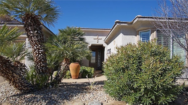 doorway to property featuring stucco siding